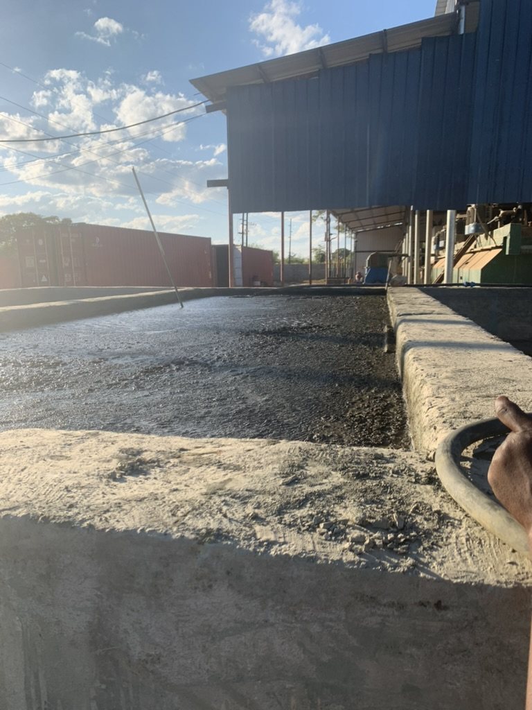 Processed material in a concrete tank beside the plant