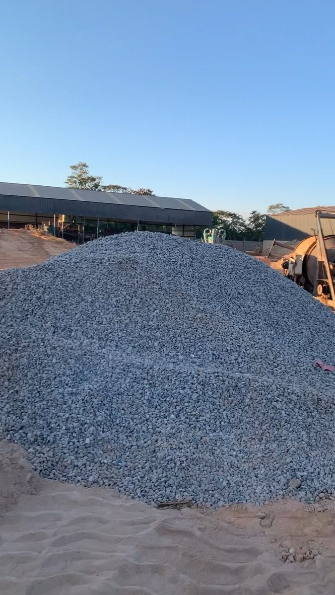 Crushed rock stockpile next to the plant sheds
