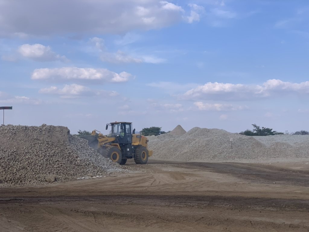 A wheel loader working a stockpile of crushed rock